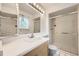 Bathroom featuring a glass enclosed shower, modern vanity, and tiled flooring at 1497 S Oakland St, Aurora, CO 80012