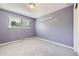 Bedroom featuring a large window, light fixture, and neutral paint at 1497 S Oakland St, Aurora, CO 80012