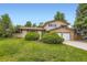 Charming two-story home with a well-maintained lawn, brick accents, and mature trees at 1497 S Oakland St, Aurora, CO 80012