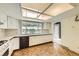 Bright kitchen features white cabinets, wood-style flooring, and ample counter space at 1497 S Oakland St, Aurora, CO 80012