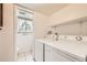 Convenient laundry area with washer, dryer, and utility sink at 1497 S Oakland St, Aurora, CO 80012
