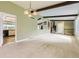 Open-concept living area leads to kitchen with neutral carpet and archways to the other rooms at 1497 S Oakland St, Aurora, CO 80012