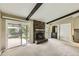 Cozy living room with a stone fireplace, sliding glass doors, and built-in shelving at 1497 S Oakland St, Aurora, CO 80012