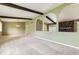 Spacious living room boasts stone fireplace, exposed beams, and arched room entrances at 1497 S Oakland St, Aurora, CO 80012