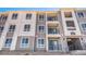 Modern apartment building exterior with multi-story design, balconies, and updated facade at 6153 N Ceylon St # 204, Denver, CO 80249