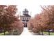 The community's recreation center is framed by flowering trees and a walkway in a welcoming neighborhood setting at 11068 Eudora Cir, Thornton, CO 80233