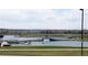 Scenic view of a pond with walking bridges, landscaping, and houses in the background, perfect for outdoor recreation at 11068 Eudora Cir, Thornton, CO 80233