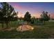 Enchanting backyard with stone pathway and landscape lighting leading to a peaceful outdoor retreat at 6371 Diamond Ridge Pkwy, Castle Rock, CO 80108