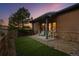 Private backyard with cozy patio, artificial grass, and mature trees, ideal for relaxation at 6371 Diamond Ridge Pkwy, Castle Rock, CO 80108