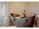 Close-up of a copper bathtub with a wooden tray, faucet, and woven basket at 6371 Diamond Ridge Pkwy, Castle Rock, CO 80108