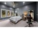 Spacious bedroom with a rustic wood bed frame, large windows, and modern decor at 6371 Diamond Ridge Pkwy, Castle Rock, CO 80108