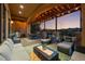 Well-appointed covered patio featuring comfortable seating areas and a barbecue grill at 6371 Diamond Ridge Pkwy, Castle Rock, CO 80108