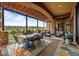 Covered patio boasts ample seating and dining areas with views of golf course at 6371 Diamond Ridge Pkwy, Castle Rock, CO 80108