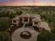 Stunning aerial view of a custom home with a circular driveway and beautiful landscaping at 6371 Diamond Ridge Pkwy, Castle Rock, CO 80108