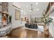 Spacious living room featuring a stone fireplace, hardwood floors, and scenic views at 6371 Diamond Ridge Pkwy, Castle Rock, CO 80108