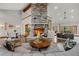 Spacious living room featuring a stone fireplace, hardwood floors, and elegant decor at 6371 Diamond Ridge Pkwy, Castle Rock, CO 80108