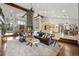 Open-concept living space with stone fireplace, wood beams, and ample seating at 6371 Diamond Ridge Pkwy, Castle Rock, CO 80108
