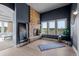 Inviting living room with a stone fireplace, bright windows, and modern decor at 6371 Diamond Ridge Pkwy, Castle Rock, CO 80108