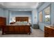 Bedroom with wood furnishings, neutral walls, and ample natural light from the windows at 6371 Diamond Ridge Pkwy, Castle Rock, CO 80108