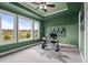 Comfortable home office with a standing desk and large windows overlooking a golf course at 6371 Diamond Ridge Pkwy, Castle Rock, CO 80108