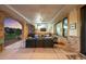 Comfortable covered patio with TV, outdoor furniture and stone details creating an inviting space at 6371 Diamond Ridge Pkwy, Castle Rock, CO 80108