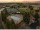Aerial view of a neighborhood recreational area, showcasing the sparkling pool, tennis courts and surrounding greenery at 6371 Diamond Ridge Pkwy, Castle Rock, CO 80108