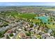 Aerial view of the neighborhood with lake and open fields in the background at 10550 Sedalia St, Commerce City, CO 80022