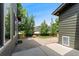 Brick patio with a lawn is surrounded by fencing, trees, and the home's siding at 10550 Sedalia St, Commerce City, CO 80022
