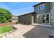 Spacious backyard featuring a brick patio, a grassy lawn, and tasteful landscaping at 10550 Sedalia St, Commerce City, CO 80022