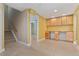 Finished basement area with tile flooring, built-in cabinets, and carpeted stairs at 10550 Sedalia St, Commerce City, CO 80022