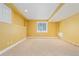 Finished basement area with neutral carpeting and a window for natural light at 10550 Sedalia St, Commerce City, CO 80022