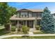 Charming two-story home with a covered front porch and well-manicured lawn at 10550 Sedalia St, Commerce City, CO 80022