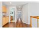 Bright hallway with hardwood floors connects various rooms, providing a seamless flow throughout the home at 10550 Sedalia St, Commerce City, CO 80022