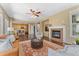 Inviting living room with fireplace, hardwood floors, and open access to the kitchen, perfect for entertaining at 10550 Sedalia St, Commerce City, CO 80022