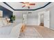Well-lit main bedroom with a tray ceiling, connecting doors to the bathroom and a walk-in closet at 10550 Sedalia St, Commerce City, CO 80022