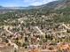Panoramic aerial view of homes nestled in a lush, mountainous area, surrounded by natural beauty at 6584 Pike Cir, Larkspur, CO 80118
