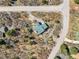Serene aerial view of a beautiful property with a private driveway, lush trees, and inviting outdoor spaces at 6584 Pike Cir, Larkspur, CO 80118
