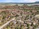 Expansive aerial view of a neighborhood nestled among rock formations, mature trees, and scenic roads at 6584 Pike Cir, Larkspur, CO 80118