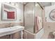 Bathroom featuring a pedestal sink, tiled shower and floors, and a large frosted window at 6584 Pike Cir, Larkspur, CO 80118