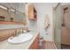 Well-lit bathroom featuring a vanity with wood cabinets, tile floor and enclosed glass walk-in shower at 6584 Pike Cir, Larkspur, CO 80118