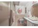 Bathroom features a frosted glass shower door, vanity and framed mirror, and peach-tone tile at 6584 Pike Cir, Larkspur, CO 80118
