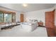 Comfortable bedroom offering natural light, wood floors, and serene forest views at 6584 Pike Cir, Larkspur, CO 80118