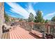 Inviting outdoor deck area offering stunning views with comfortable seating arrangements and planting container at 6584 Pike Cir, Larkspur, CO 80118