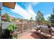 Outdoor deck offering scenic views, complete with a grill, dining table, and comfortable seating area at 6584 Pike Cir, Larkspur, CO 80118