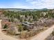 Scenic home with a lush forest view and mountains in the distance, surrounded by mature trees and natural beauty at 6584 Pike Cir, Larkspur, CO 80118