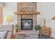 Rustic brick fireplace with a log mantel and decorative accents, creating a warm and inviting atmosphere at 6584 Pike Cir, Larkspur, CO 80118