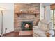Inviting fireplace with stone surround, wood mantle, and a cozy armchair for relaxing fireside moments at 6584 Pike Cir, Larkspur, CO 80118