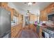 Spacious kitchen featuring wooden cabinets, stainless steel appliances, and ample counter space for cooking and preparation at 6584 Pike Cir, Larkspur, CO 80118