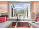 Kitchen featuring a double basin copper sink and a large window offering a bright and scenic view of the mountains at 6584 Pike Cir, Larkspur, CO 80118