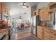 Well-lit kitchen with stainless steel appliances, wooden cabinets, and an adjacent dining area for casual meals at 6584 Pike Cir, Larkspur, CO 80118